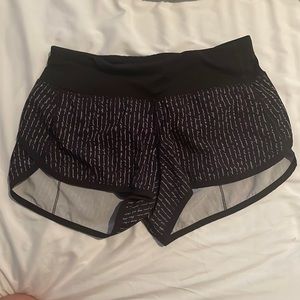 Lululemon speed-ups, size 2 in black with writing.